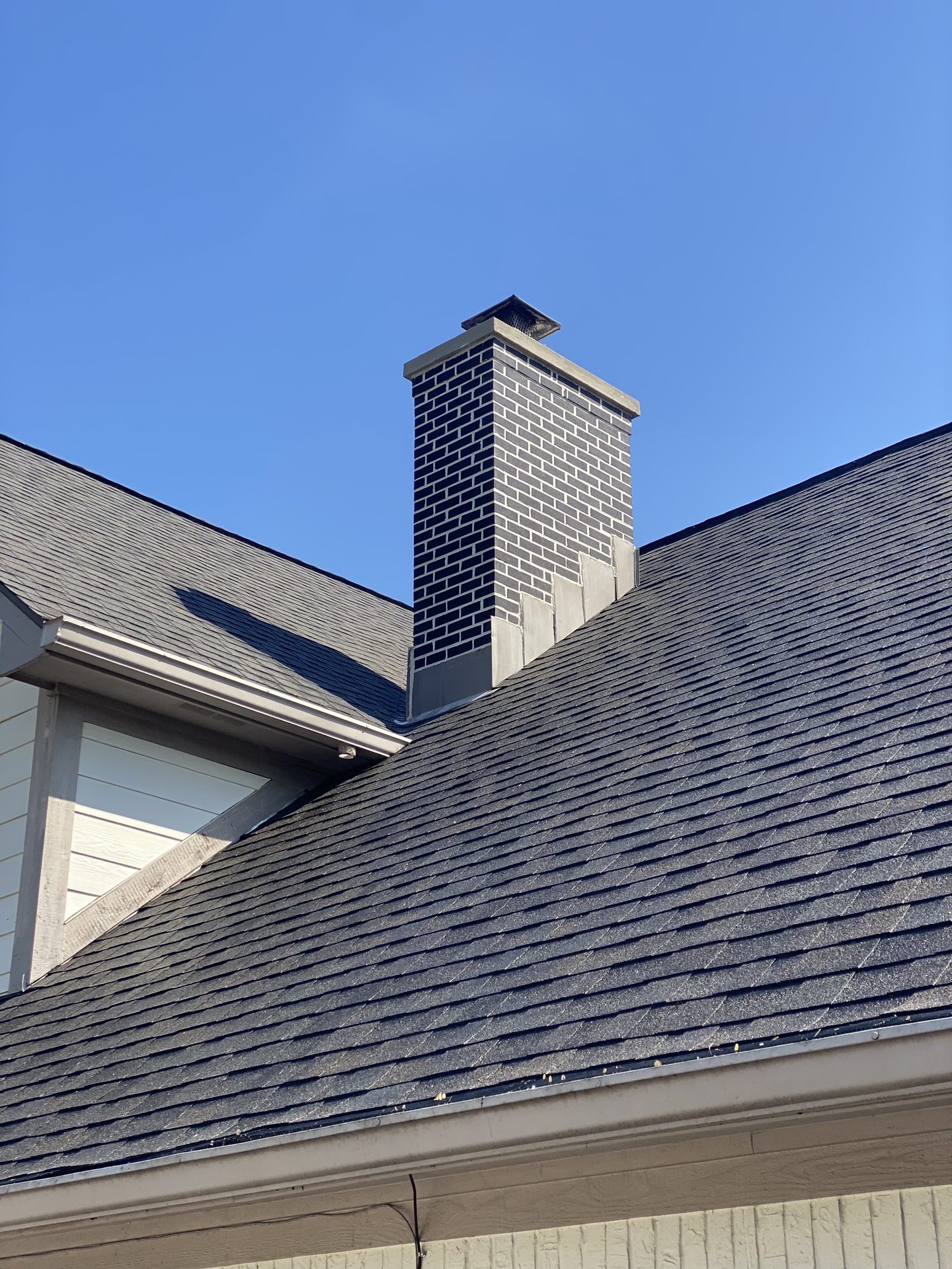 Dark brick chimney construction with flashing by masonry contractor Marion County, Indiana Dark brick chimney construction with flashing by masonry contractor Marion County, Indiana